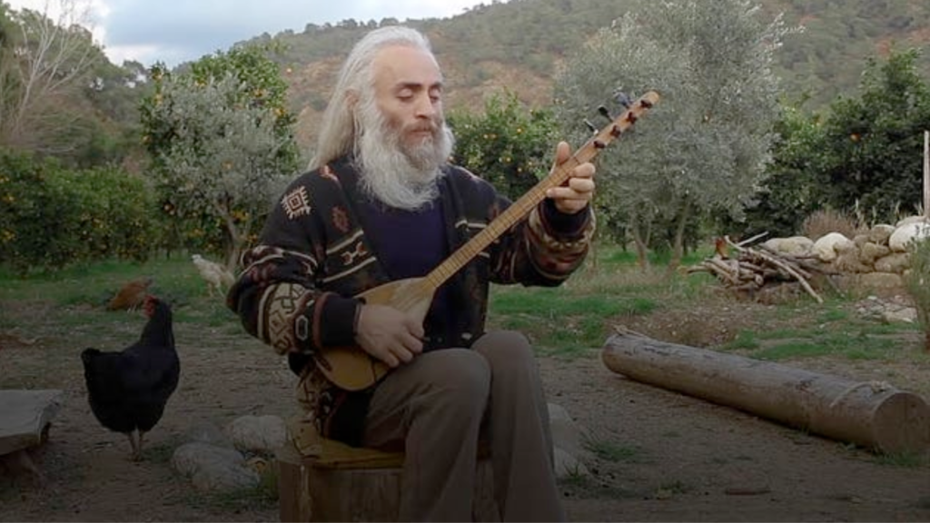 Musician ÖZGÜR BABA playing the cura & singing the words of poet Yunus Emre